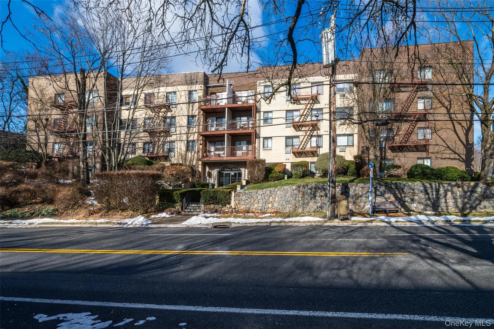 View of apartment building / complex with uncovered parking View of apartment building / complex with uncovered parking