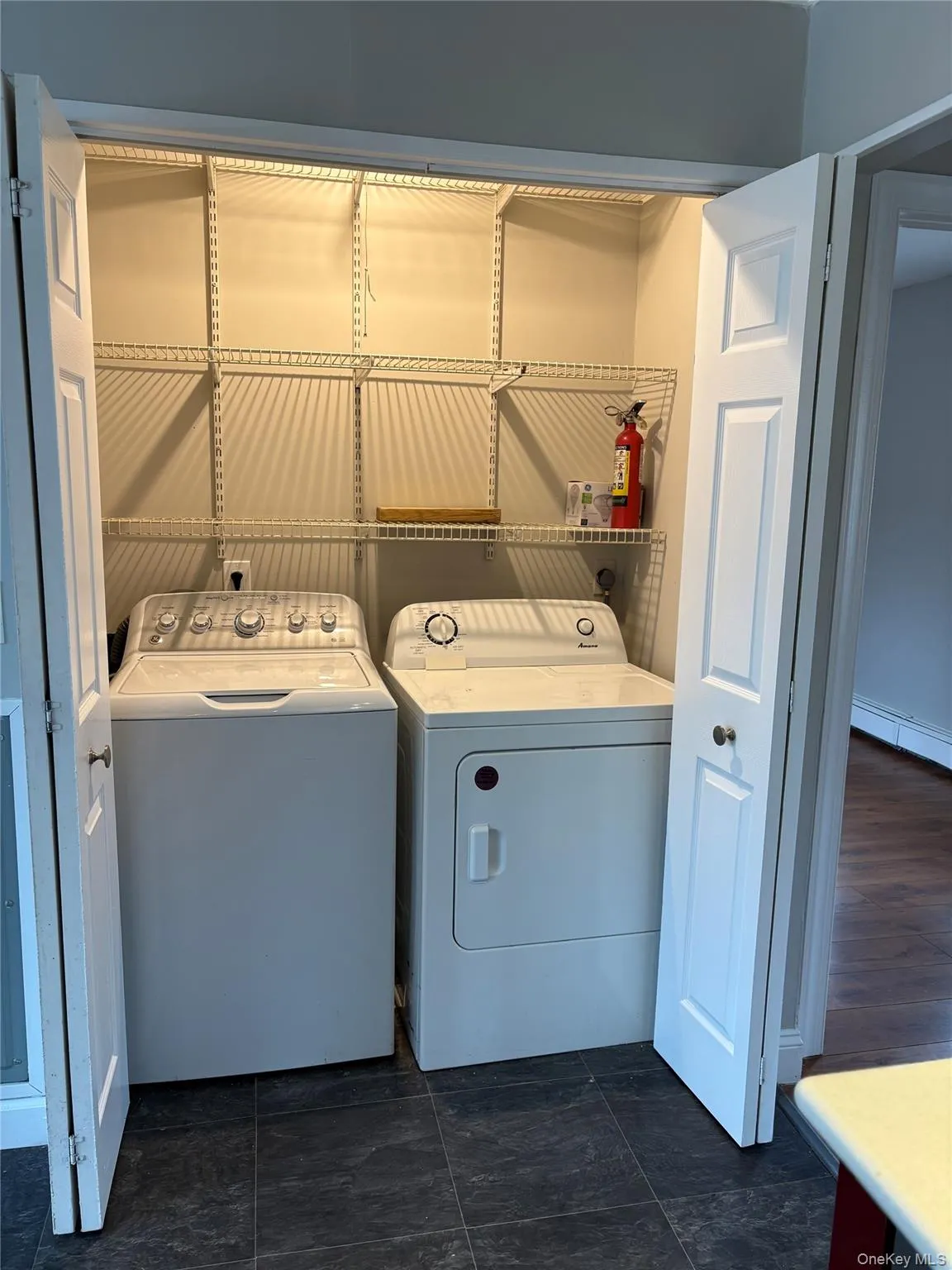 Laundry room with washer and clothes dryer and baseboard heating Laundry room with washer and clothes dryer and baseboard heating