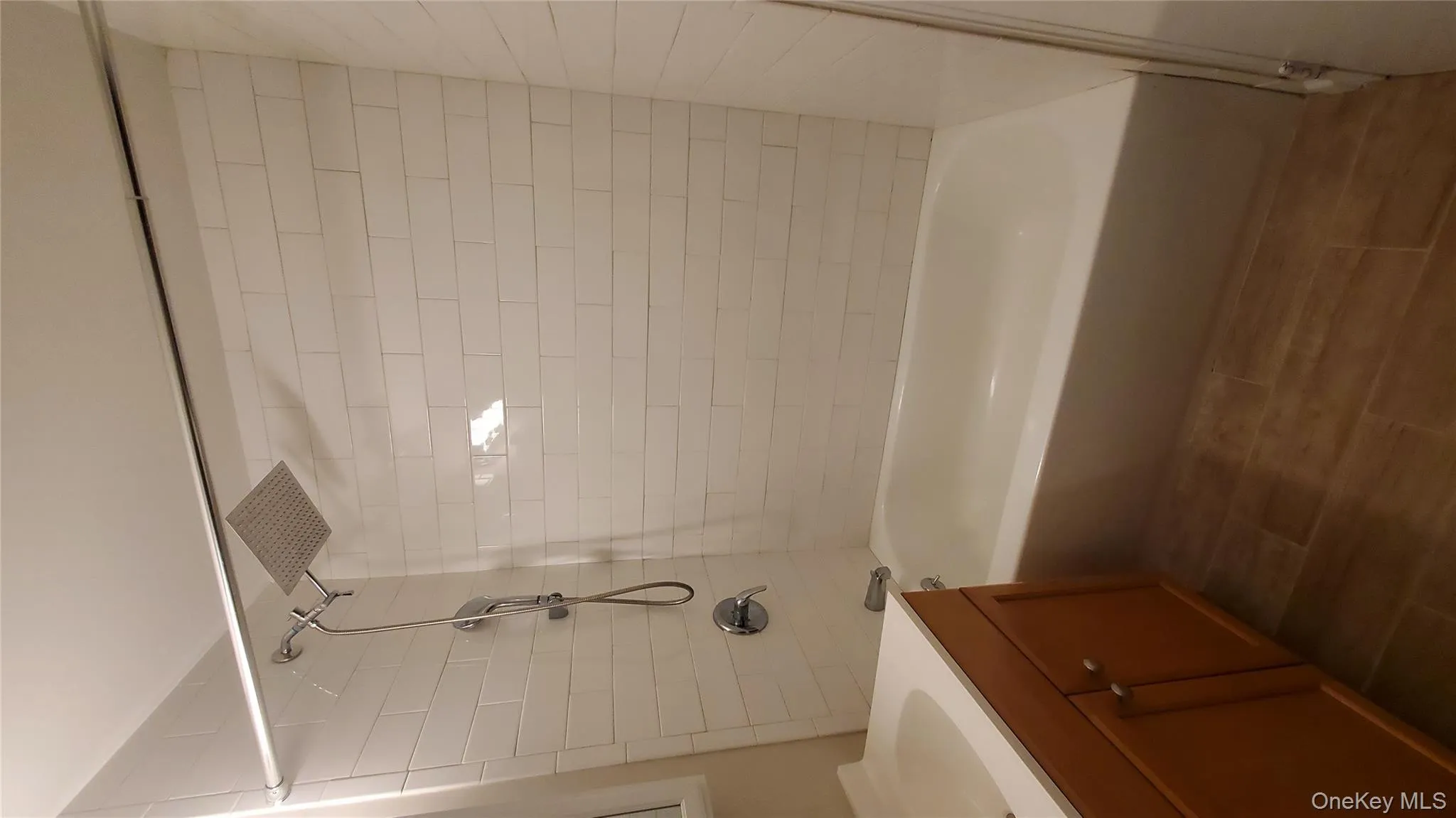 Bathroom with shower / tub combination, vanity, and wood tiled floors Bathroom with shower / tub combination, vanity, and wood tiled floors