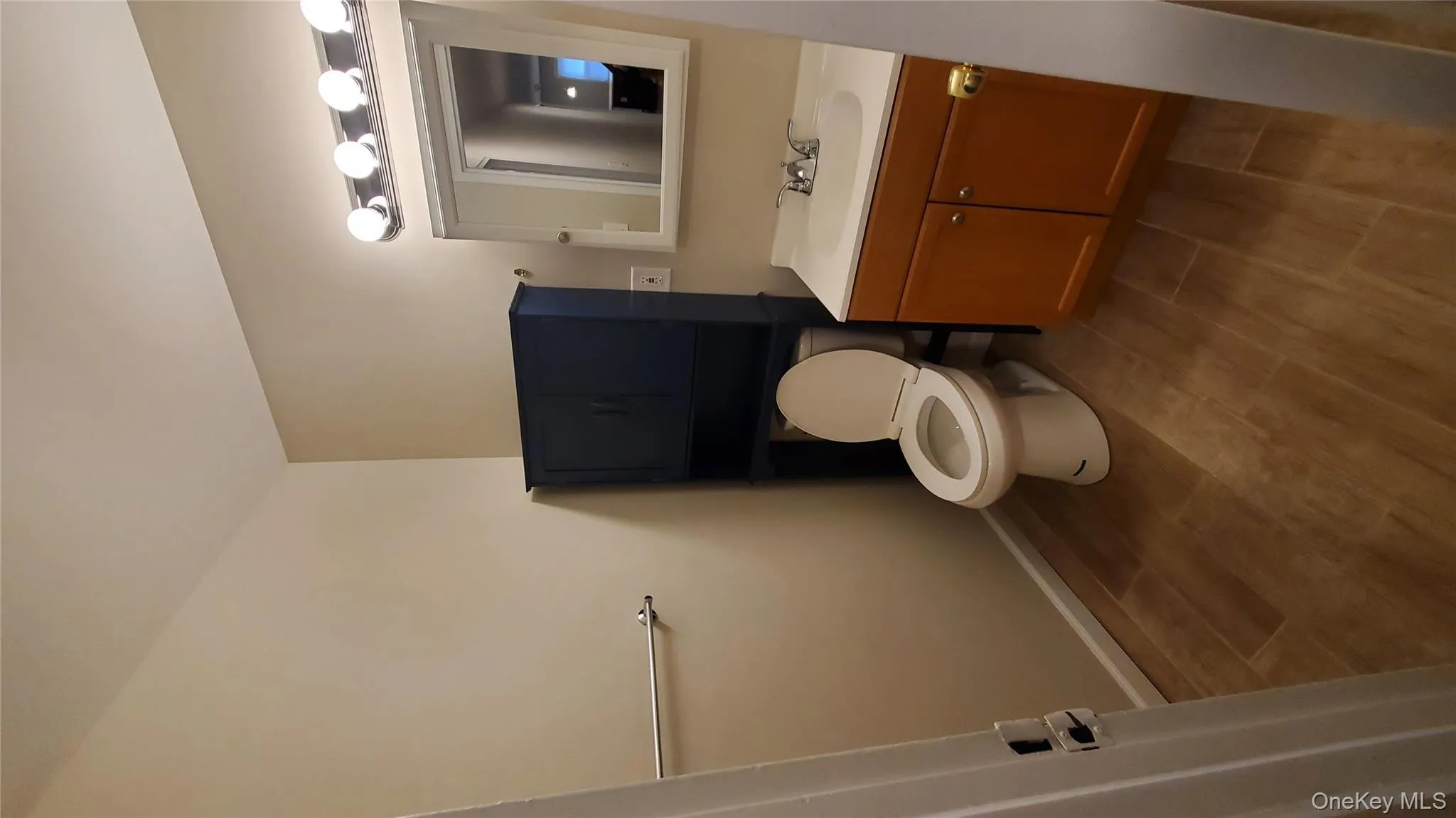 Half bathroom featuring wood finish floors and vanity Half bathroom featuring wood finish floors and vanity