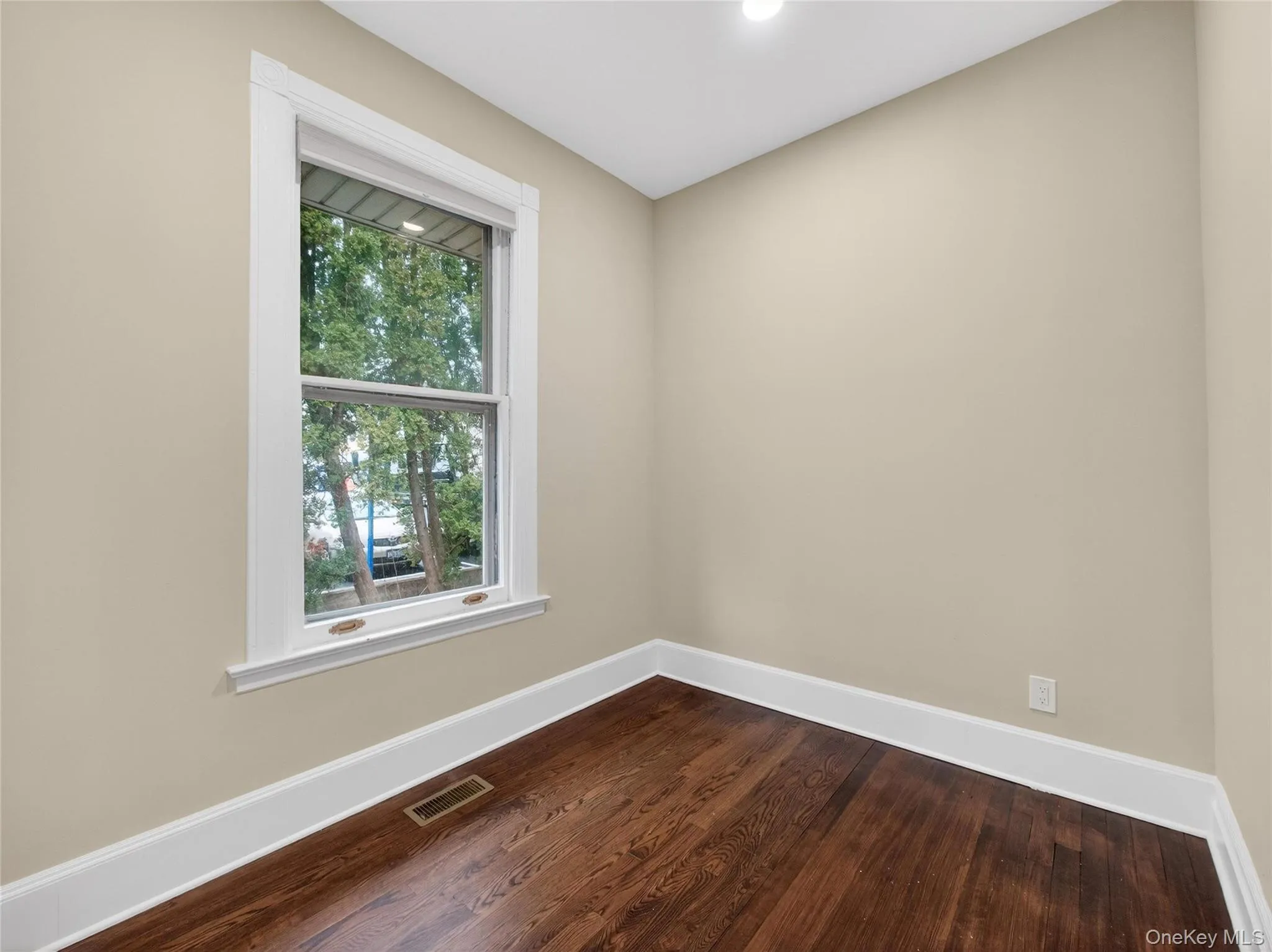 Unfurnished room with dark wood-style floors and recessed lighting Unfurnished room with dark wood-style floors and recessed lighting
