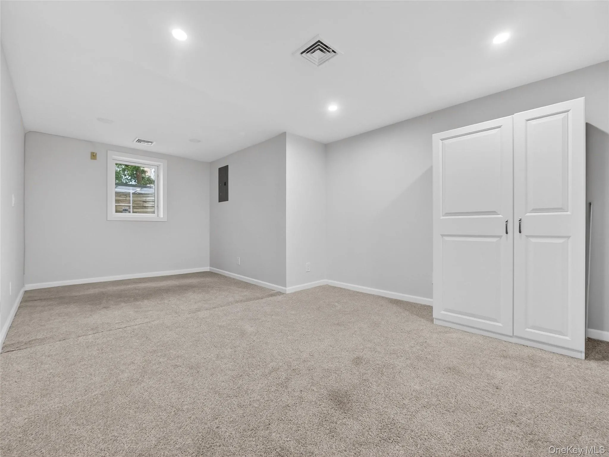 Below grade area with light carpet and recessed lighting Below grade area with light carpet and recessed lighting