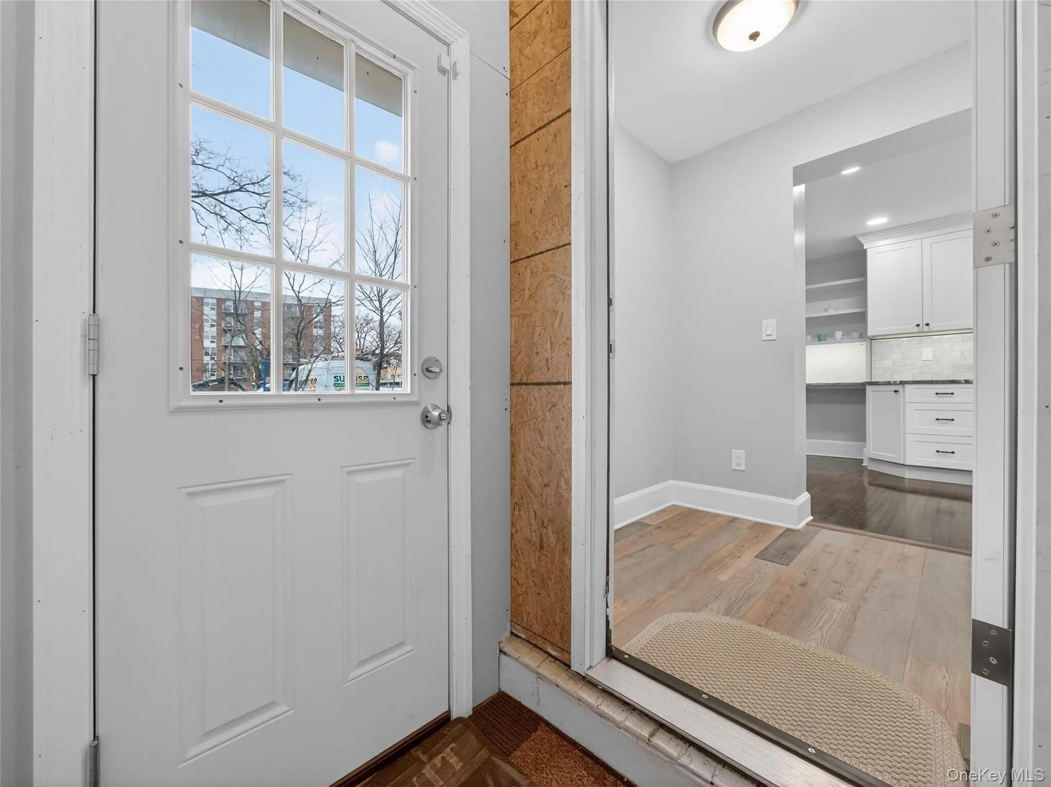 Doorway featuring wood finished floors and baseboards Doorway featuring wood finished floors and baseboards