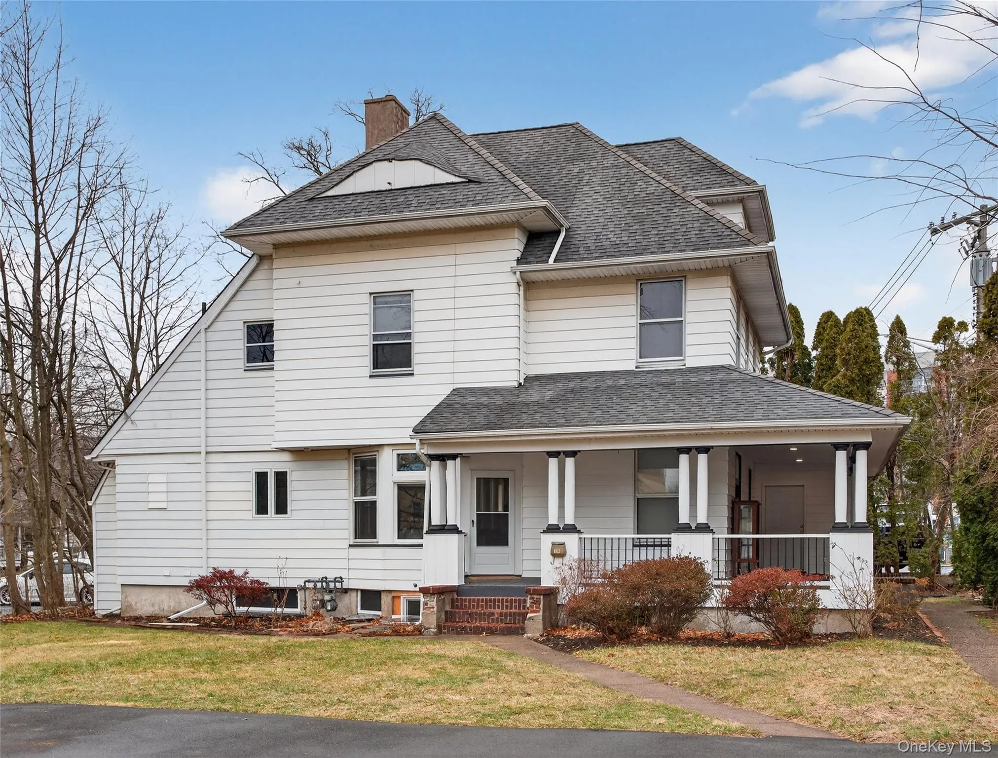 View of front of home featuring a porch, a chimney, a front lawn, and roof with shingles View of front of home featuring a porch, a chimney, a front lawn, and roof with shingles