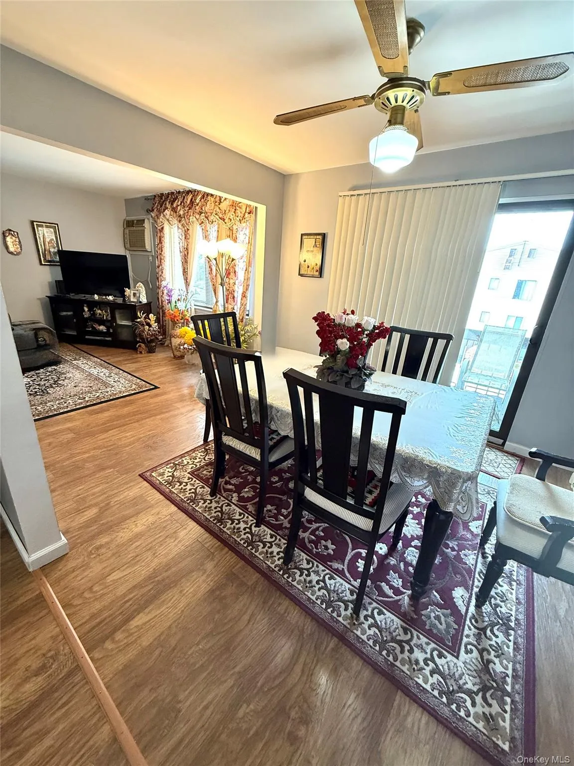 Dining area featuring wood finished floors and a ceiling fan Dining area featuring wood finished floors and a ceiling fan