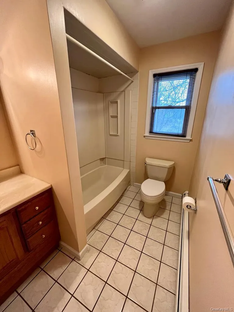 Bathroom with baseboards and shower / bathtub combination Bathroom with baseboards and shower / bathtub combination