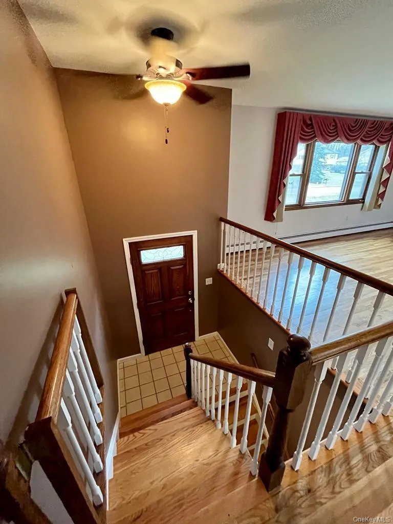 Staircase with wood finished floors and ceiling fan Staircase with wood finished floors and ceiling fan