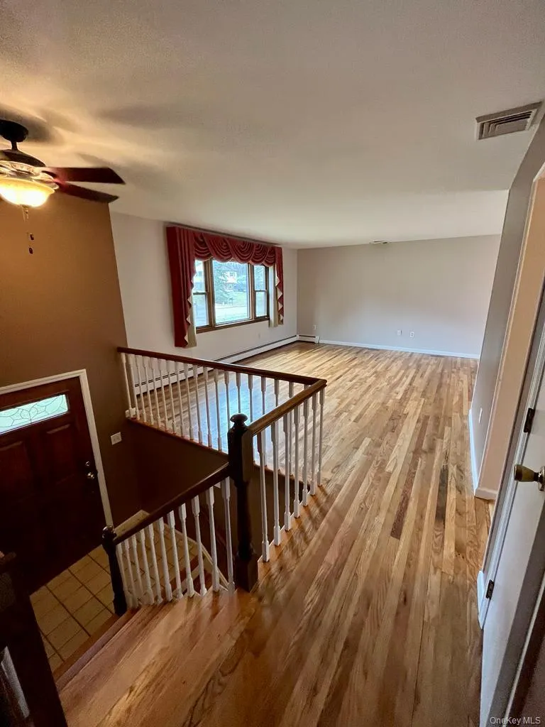 Stairway with wood finished floors and ceiling fan Stairway with wood finished floors and ceiling fan