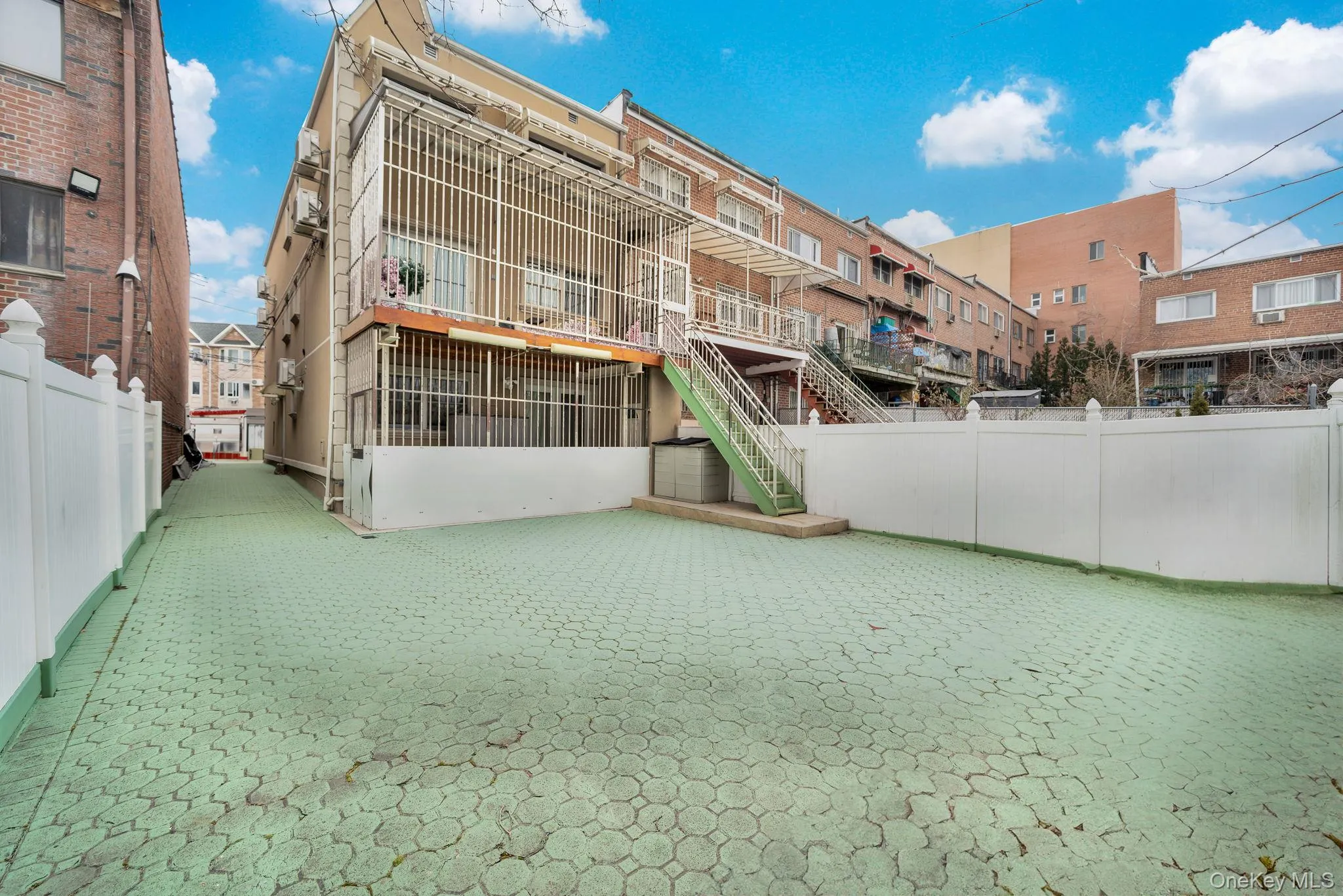 View of property's community with stairs and a balcony View of property's community with stairs and a balcony