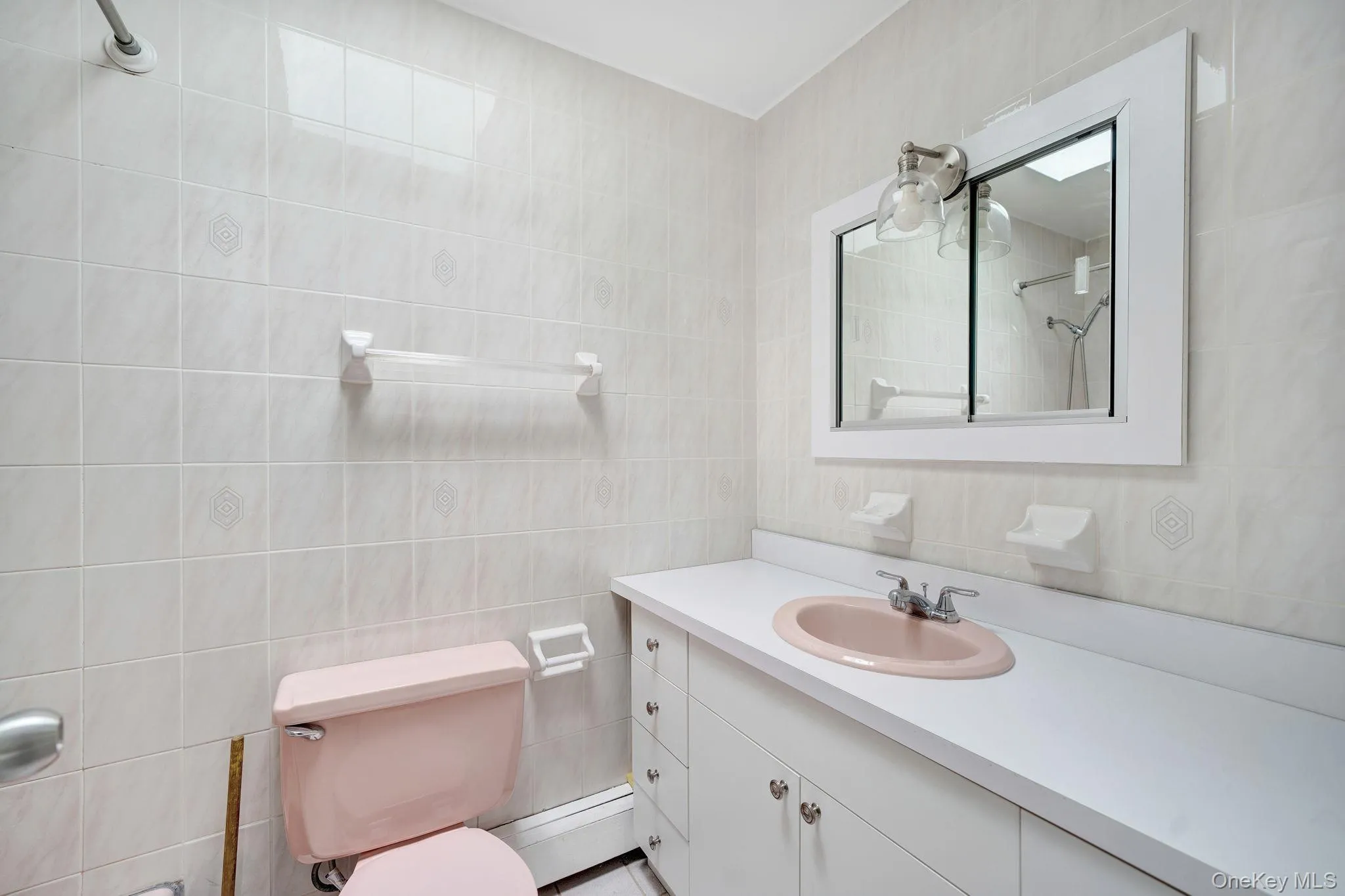 Full bathroom featuring tile walls, a shower, and vanity Full bathroom featuring tile walls, a shower, and vanity