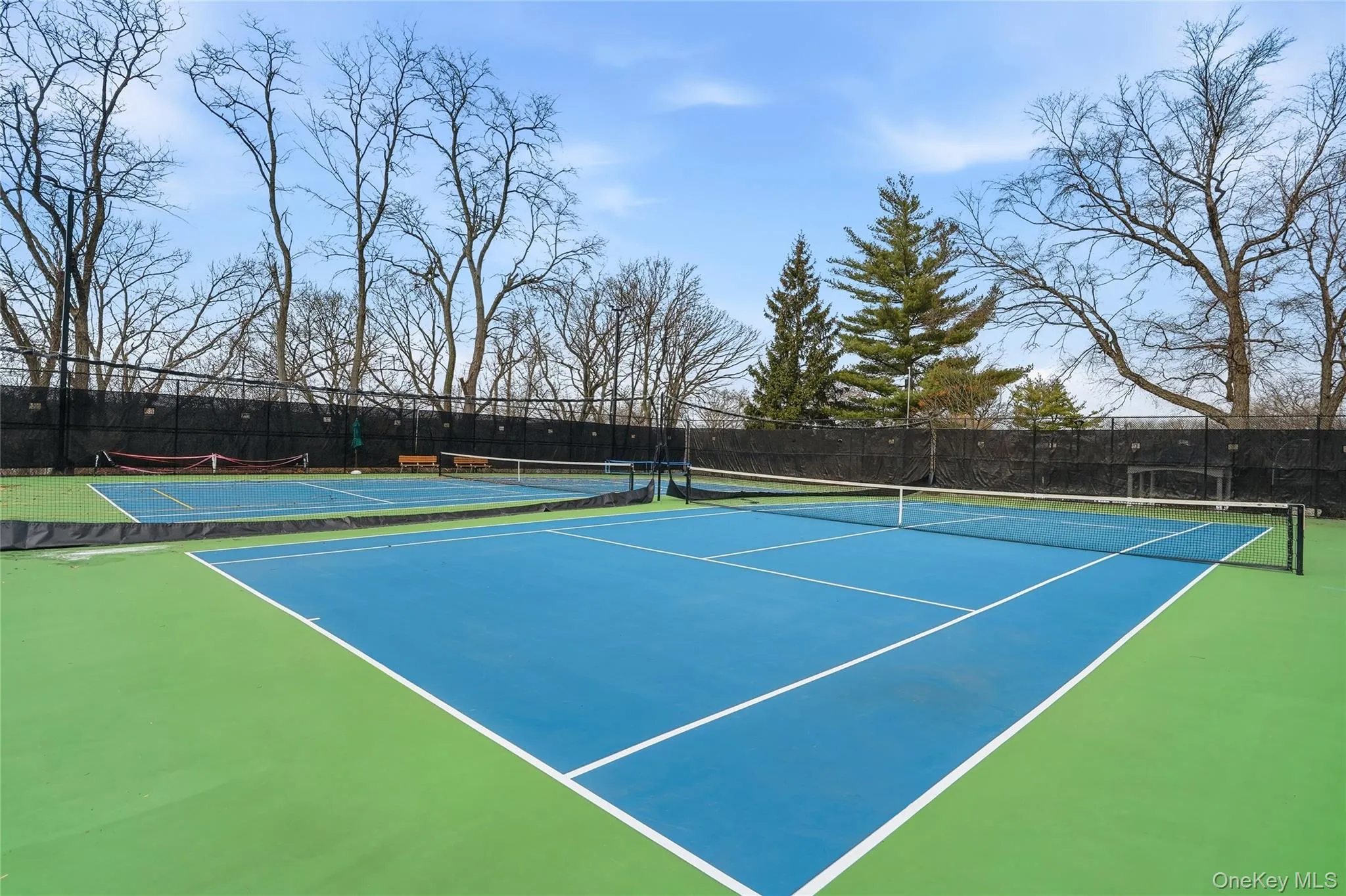 View of tennis court with community basketball court View of tennis court with community basketball court