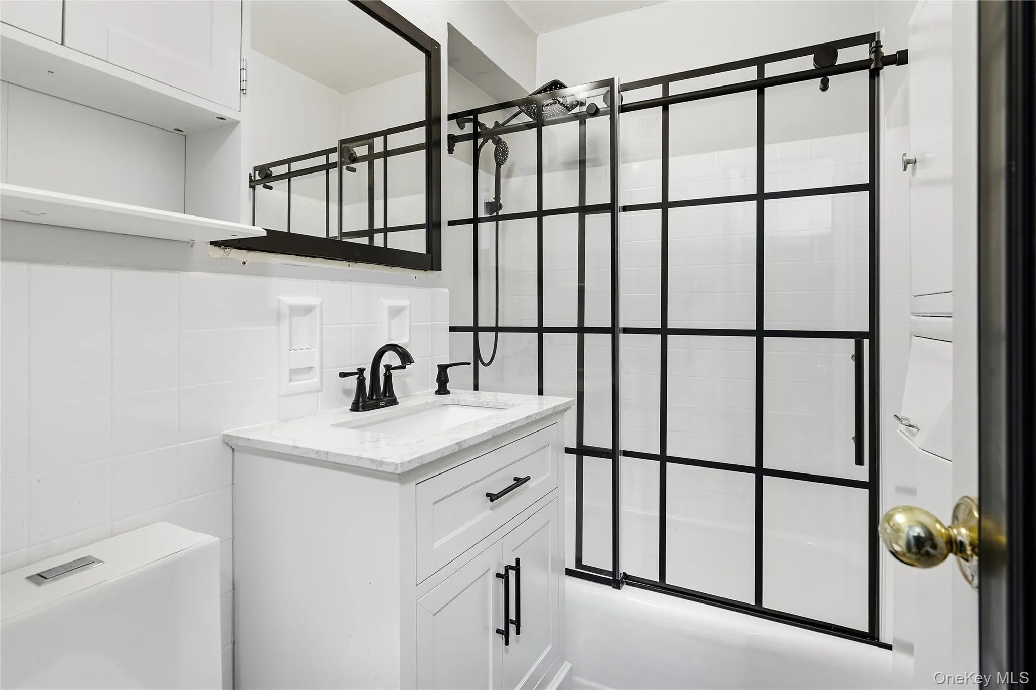 Bathroom with tub / shower combination, tile walls, and vanity Bathroom with tub / shower combination, tile walls, and vanity