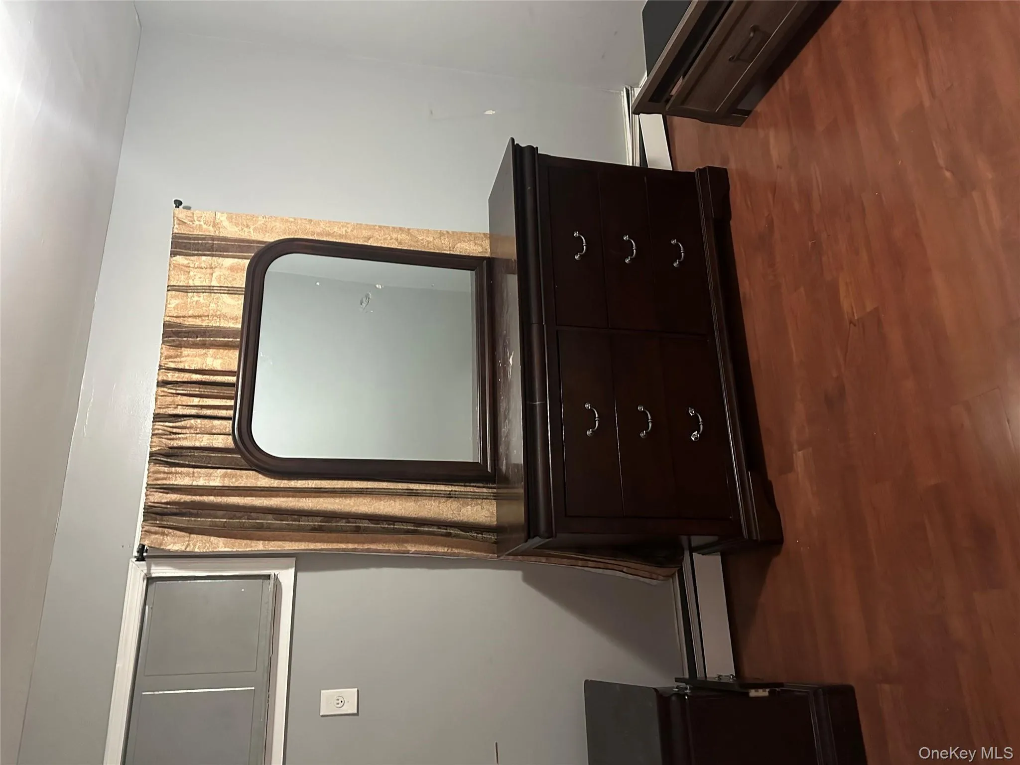 Detailed view of wood finished floors and a baseboard radiator Detailed view of wood finished floors and a baseboard radiator