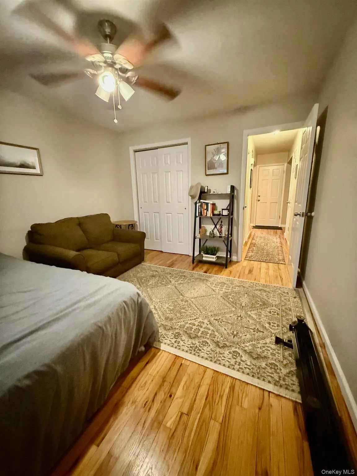 Second Bedroom featuring light wood finished floors, closet and ceiling fan Second Bedroom featuring light wood finished floors, closet and ceiling fan
