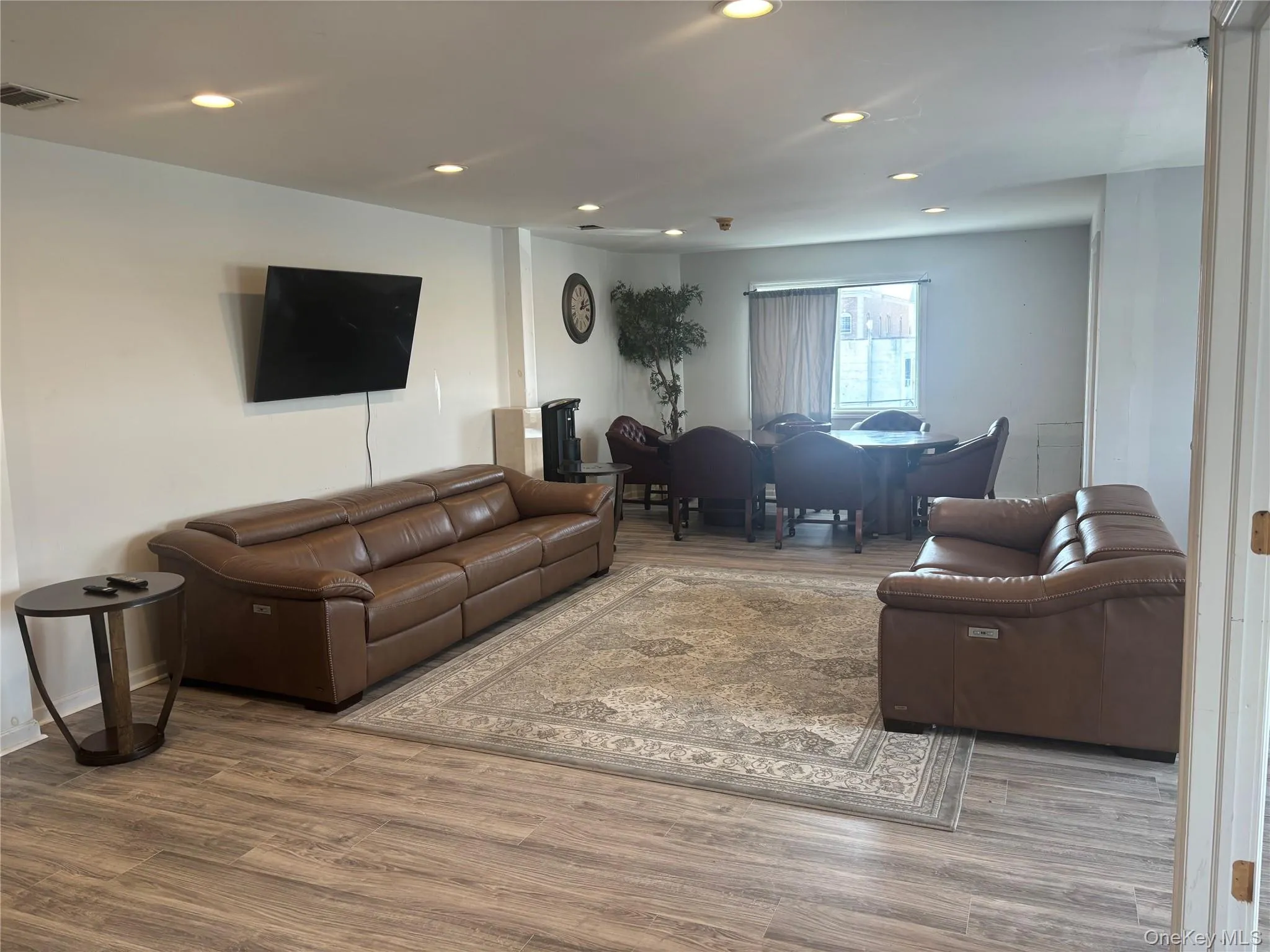Living room featuring wood finished floors and recessed lighting Living room featuring wood finished floors and recessed lighting