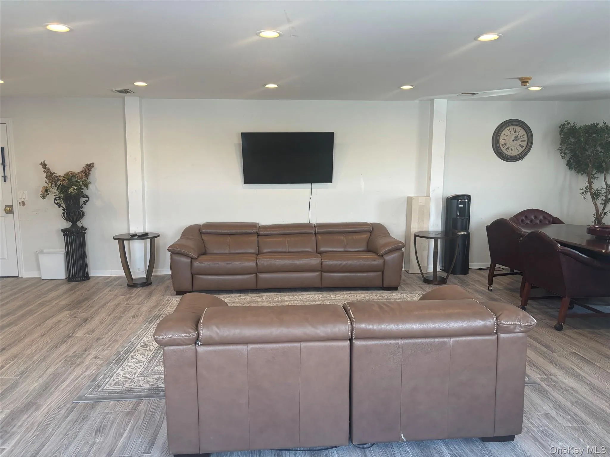 Living area featuring wood finished floors and recessed lighting Living area featuring wood finished floors and recessed lighting