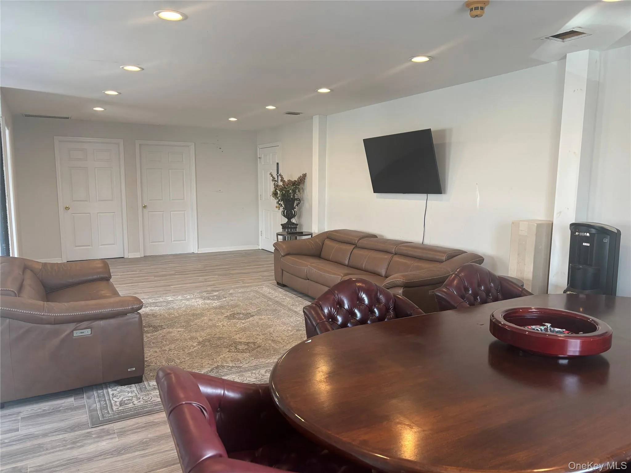 Living area with wood finished floors and recessed lighting Living area with wood finished floors and recessed lighting