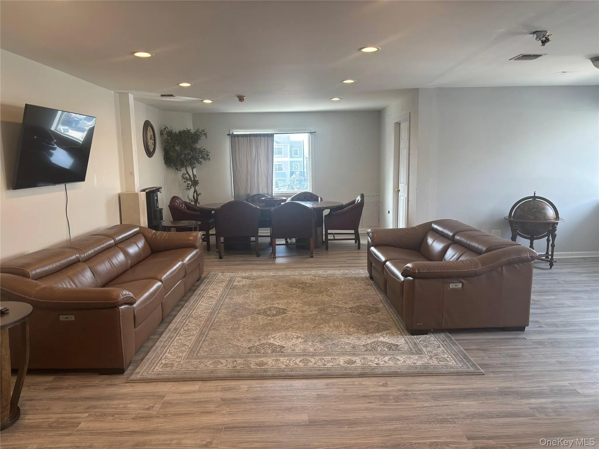 Living area with recessed lighting and light wood-style flooring Living area with recessed lighting and light wood-style flooring