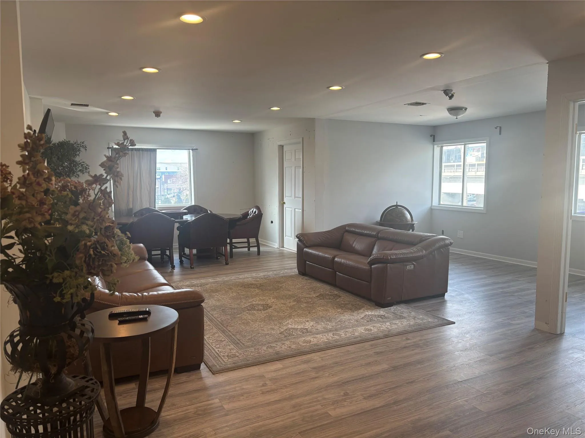 Living room with recessed lighting, healthy amount of natural light, and wood finished floors Living room with recessed lighting, healthy amount of natural light, and wood finished floors