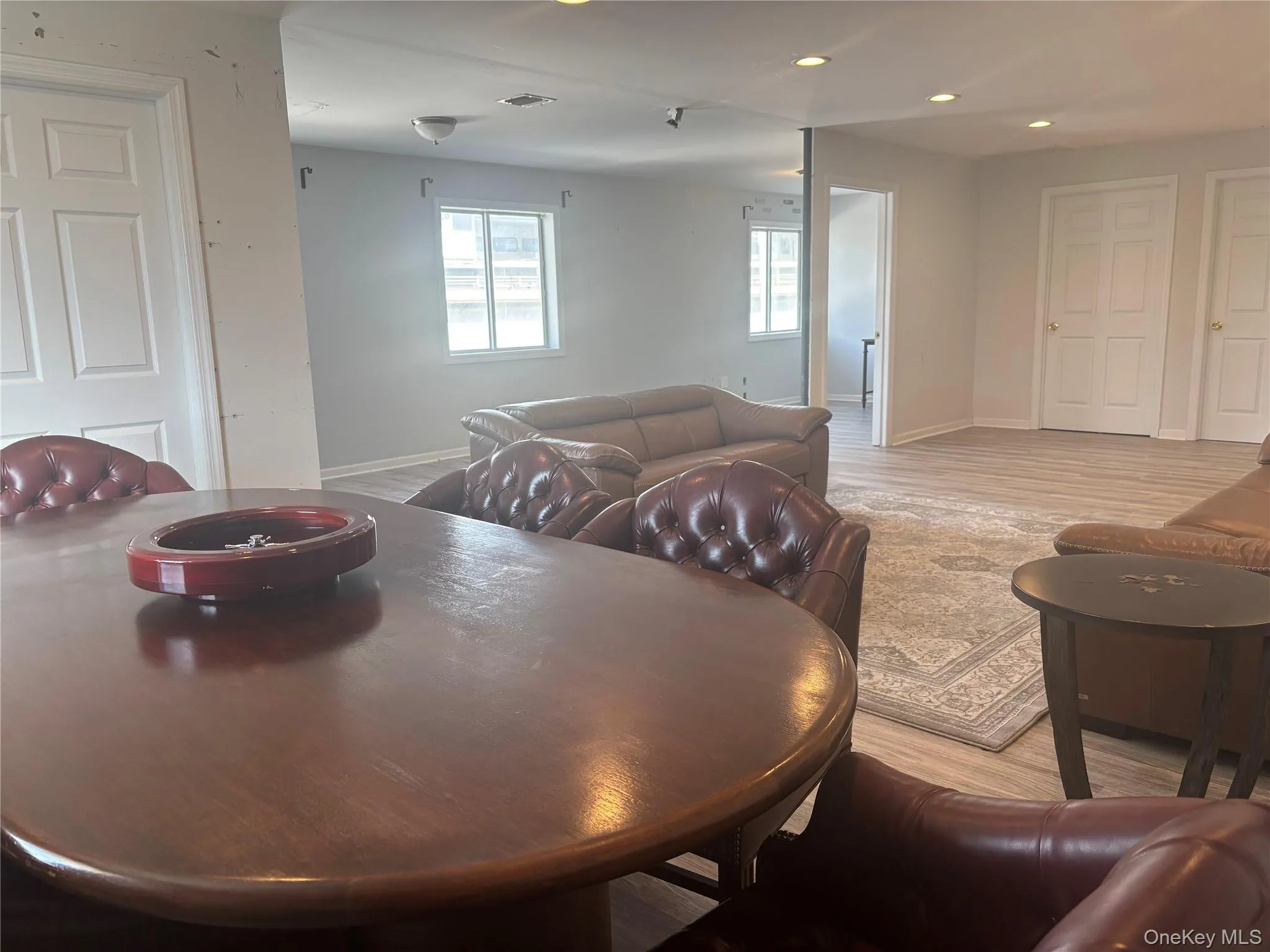 Dining area with light wood-style flooring and recessed lighting Dining area with light wood-style flooring and recessed lighting
