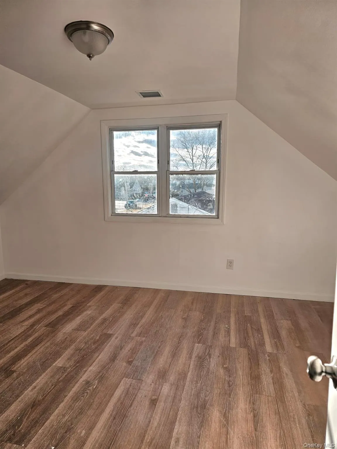 Bonus room featuring lofted ceiling and dark wood finished floors Bonus room featuring lofted ceiling and dark wood finished floors