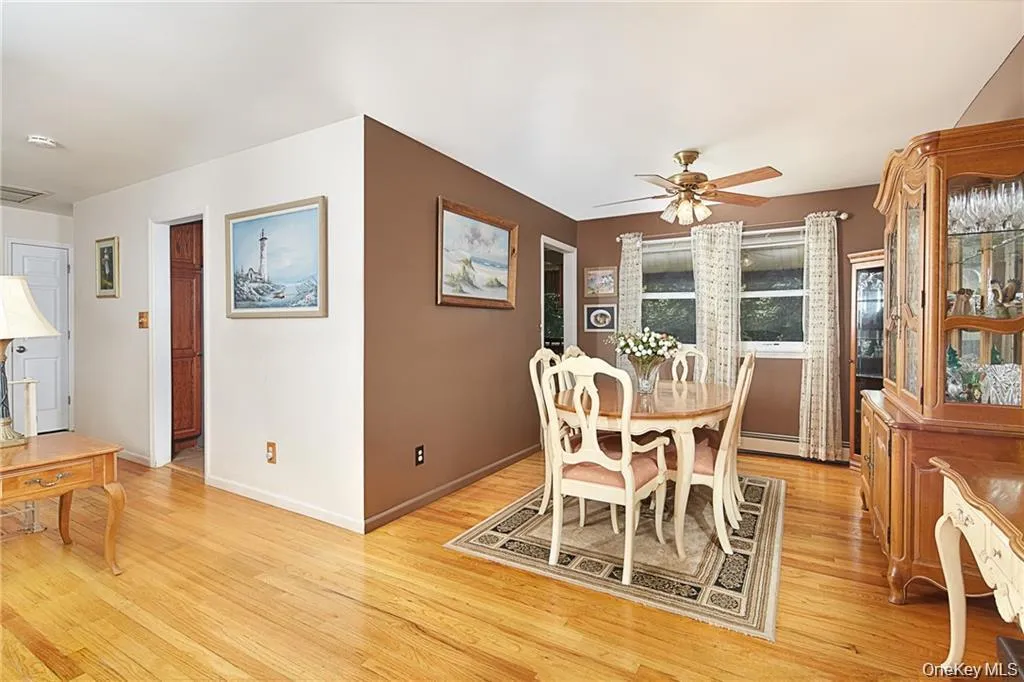 Dining room featuring light wood-style flooring and a ceiling fan Dining room featuring light wood-style flooring and a ceiling fan