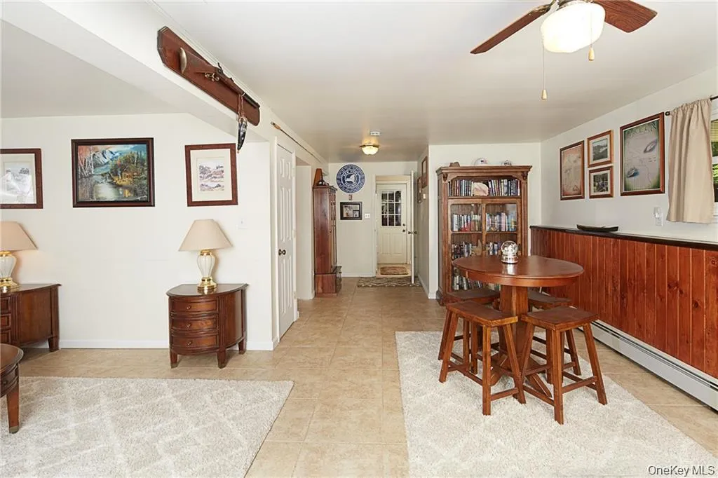 Dining space with ceiling fan and light tile patterned floors Dining space with ceiling fan and light tile patterned floors