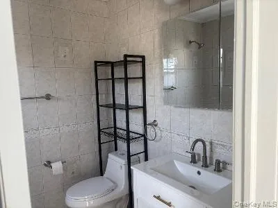 Bathroom with tile walls and vanity Bathroom with tile walls and vanity