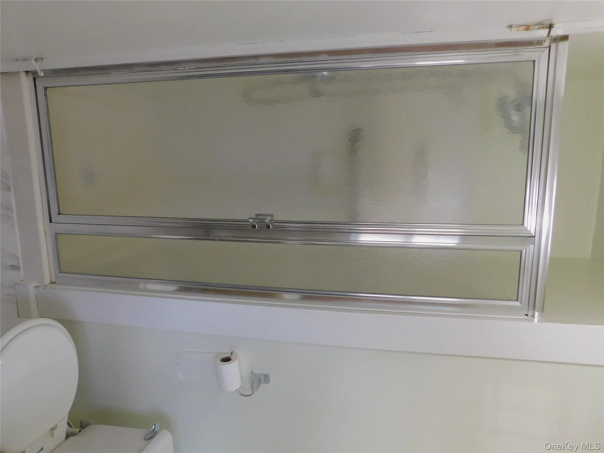 Full bath featuring a shower stall and toilet Full bath featuring a shower stall and toilet