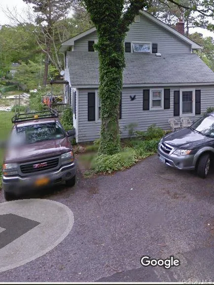 View of front of home featuring a chimney and a shingled roof View of front of home featuring a chimney and a shingled roof