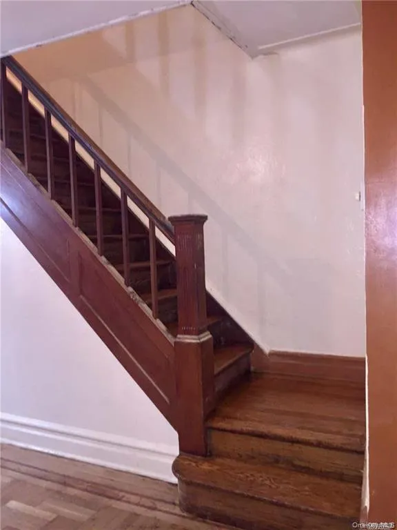 Staircase with wood finished floors and baseboards Staircase with wood finished floors and baseboards