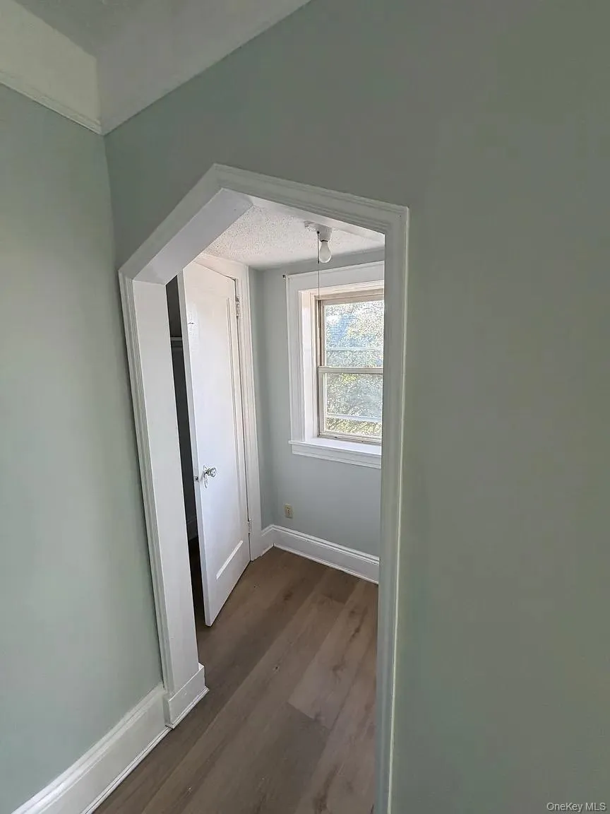 Additional living space with baseboards and dark wood-style floors Additional living space with baseboards and dark wood-style floors