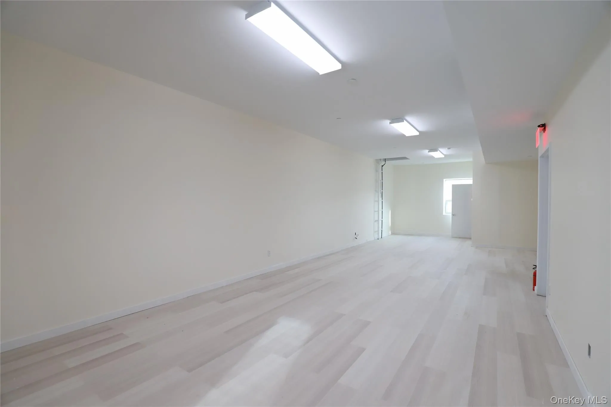 Unfurnished room with light wood finished floors and baseboards Unfurnished room with light wood finished floors and baseboards