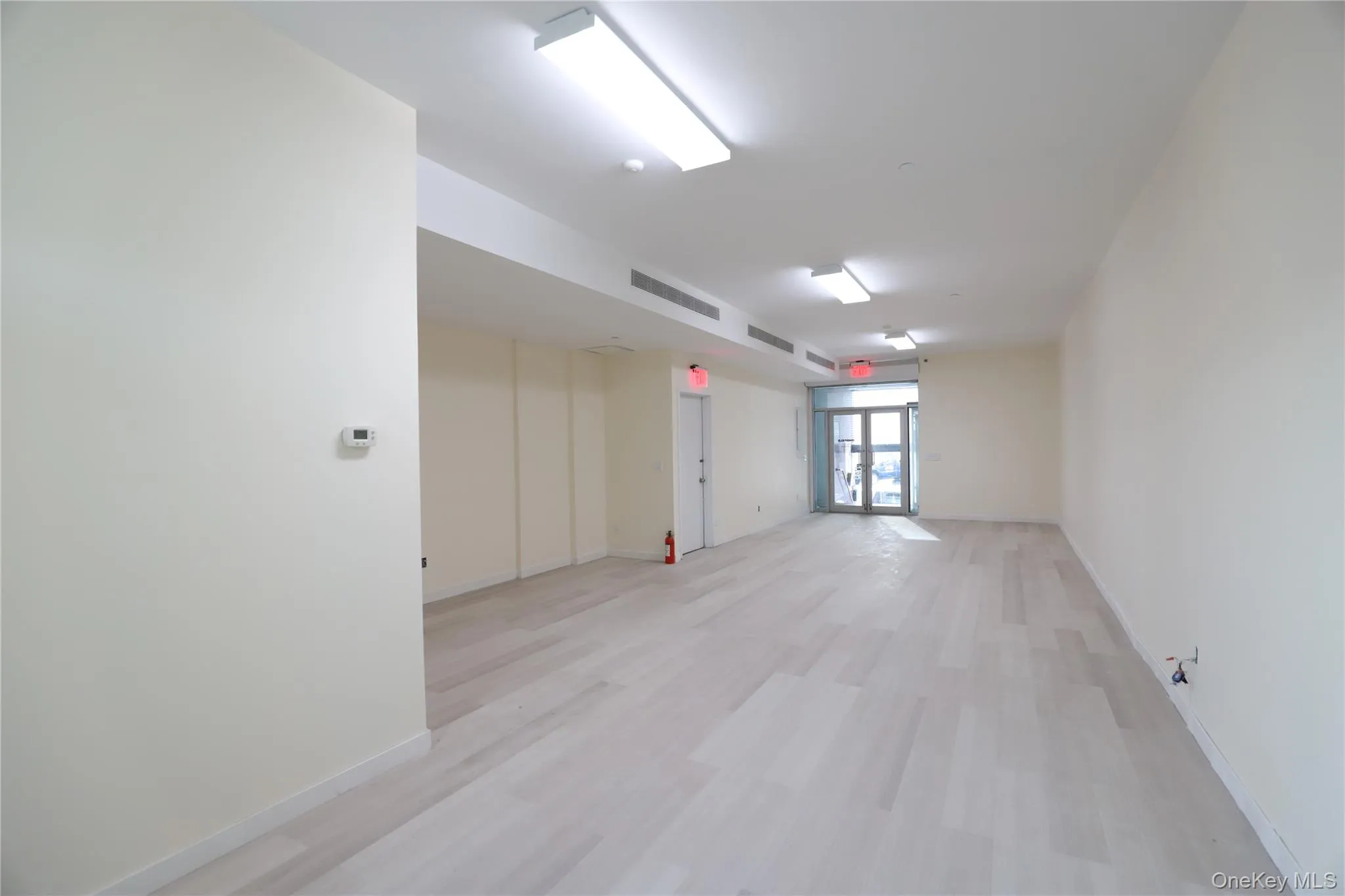 Spare room with light wood-style floors and baseboards Spare room with light wood-style floors and baseboards