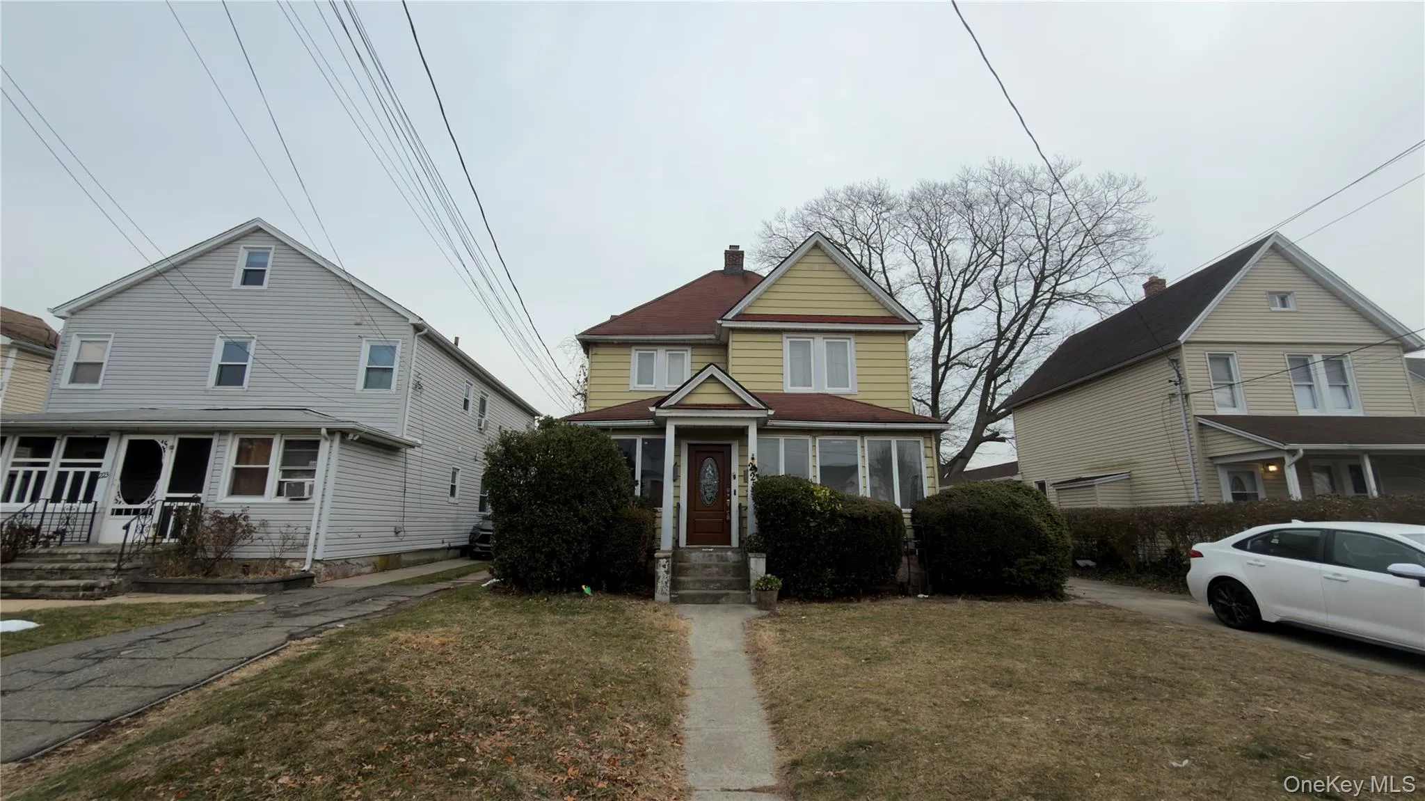 Traditional home featuring a chimney and a front lawn Traditional home featuring a chimney and a front lawn