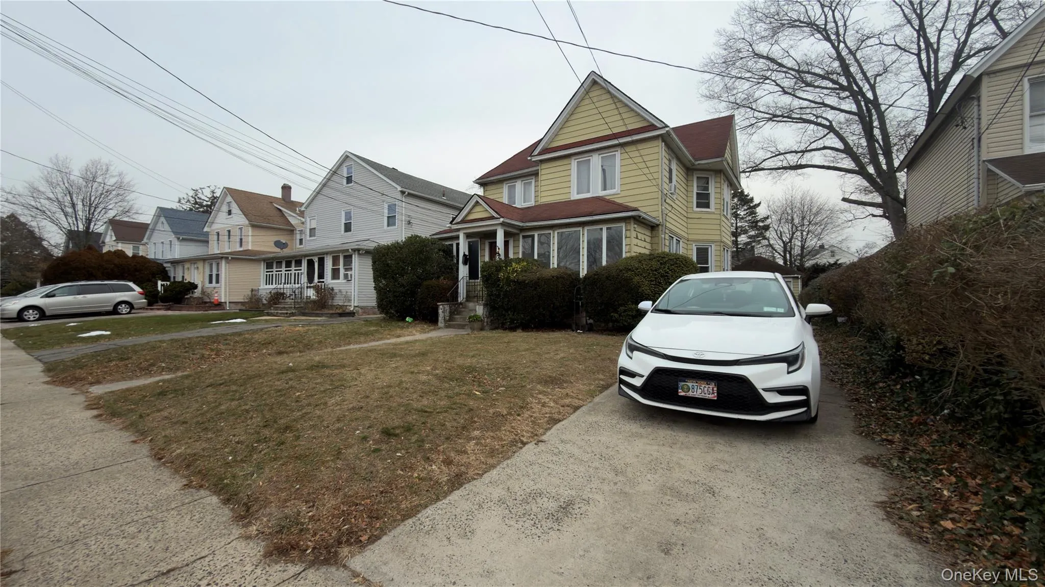 View of front of home with a front yard and a residential view View of front of home with a front yard and a residential view