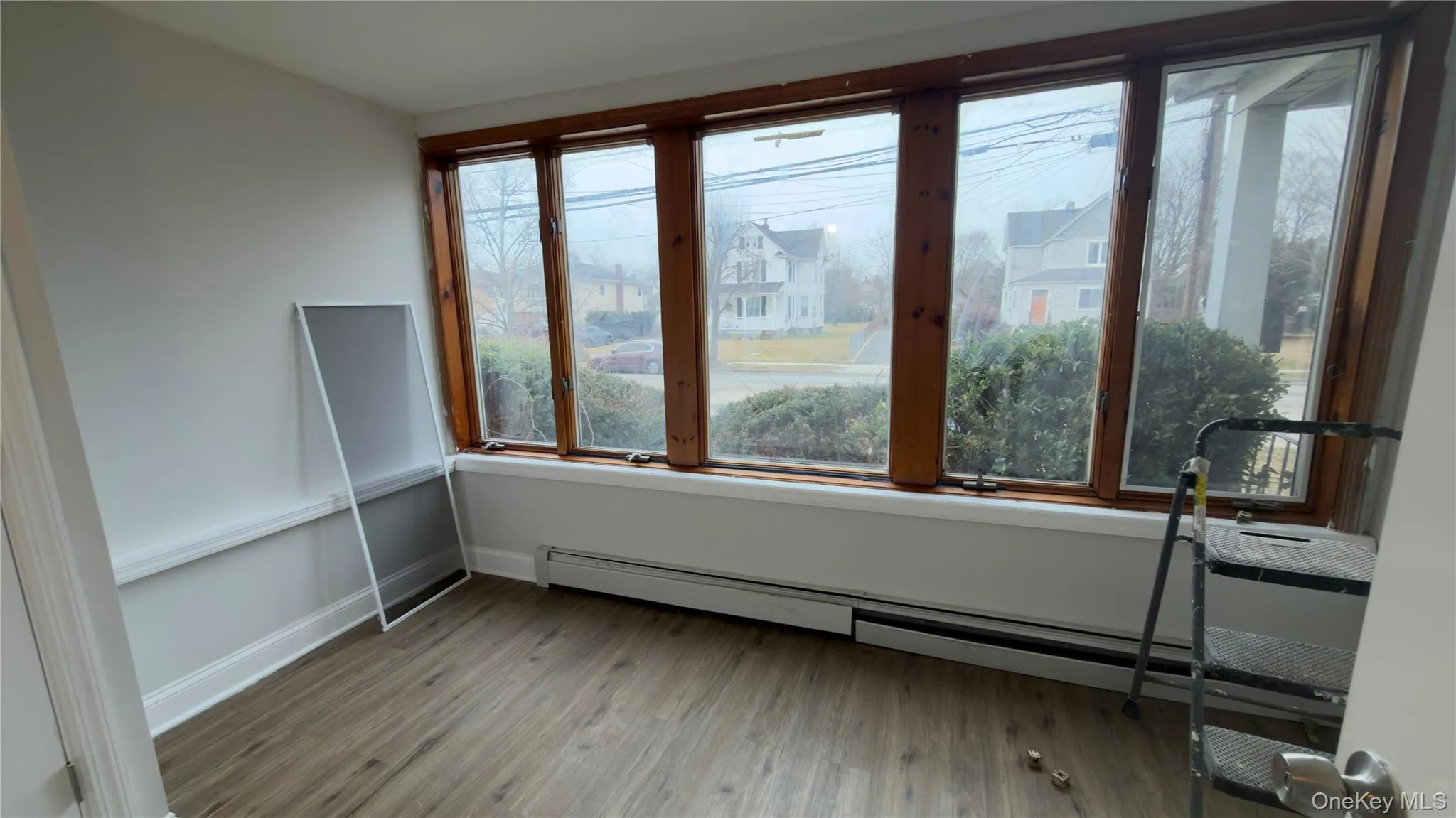 Unfurnished sunroom featuring baseboard heating Unfurnished sunroom featuring baseboard heating