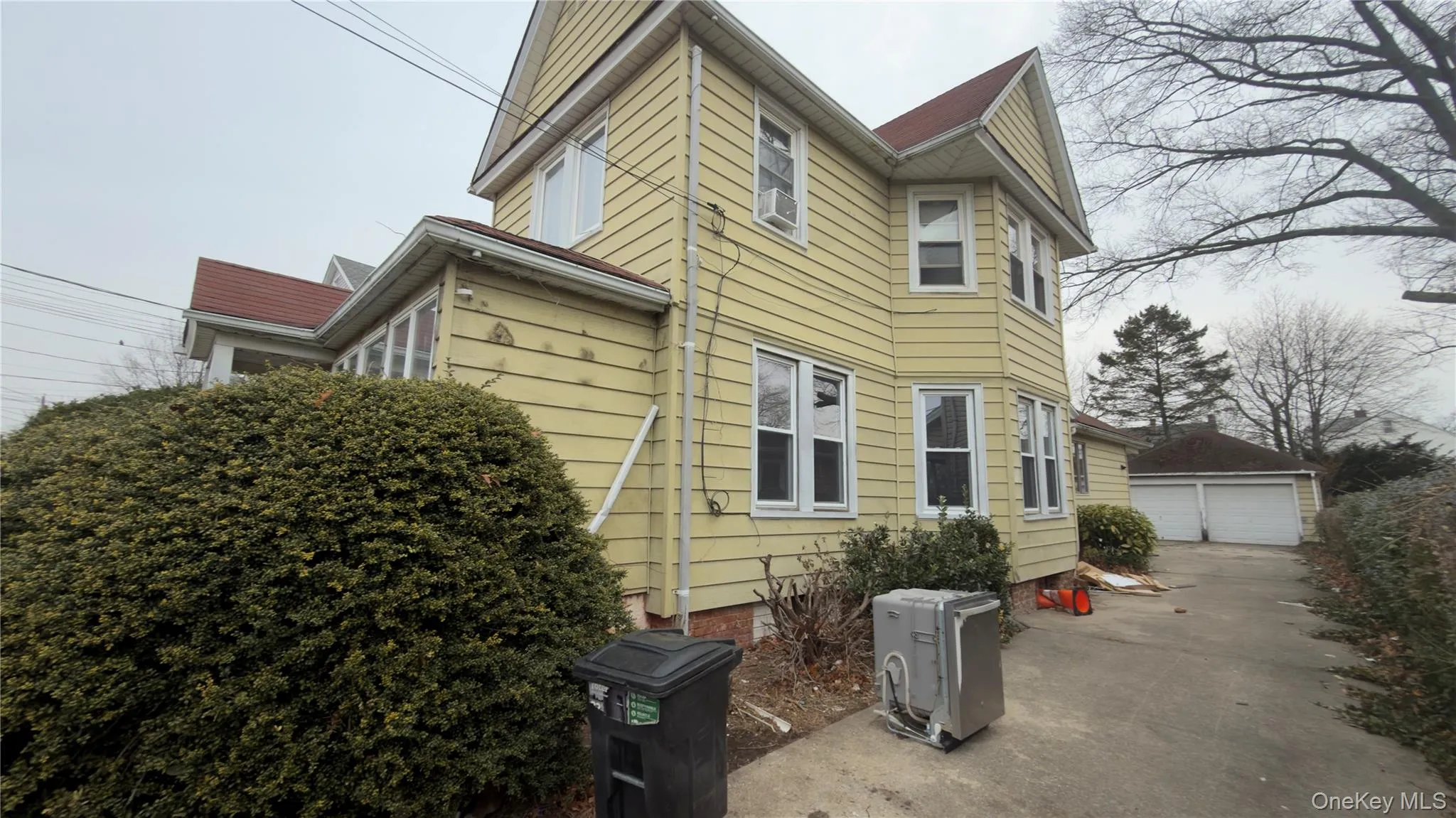 View of side of property with an outdoor structure and a garage View of side of property with an outdoor structure and a garage