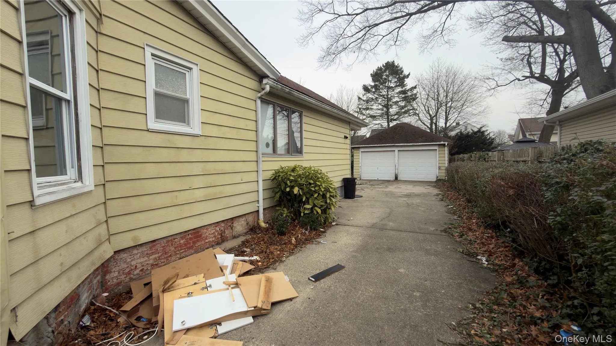 View of side of home featuring an outdoor structure and a garage View of side of home featuring an outdoor structure and a garage