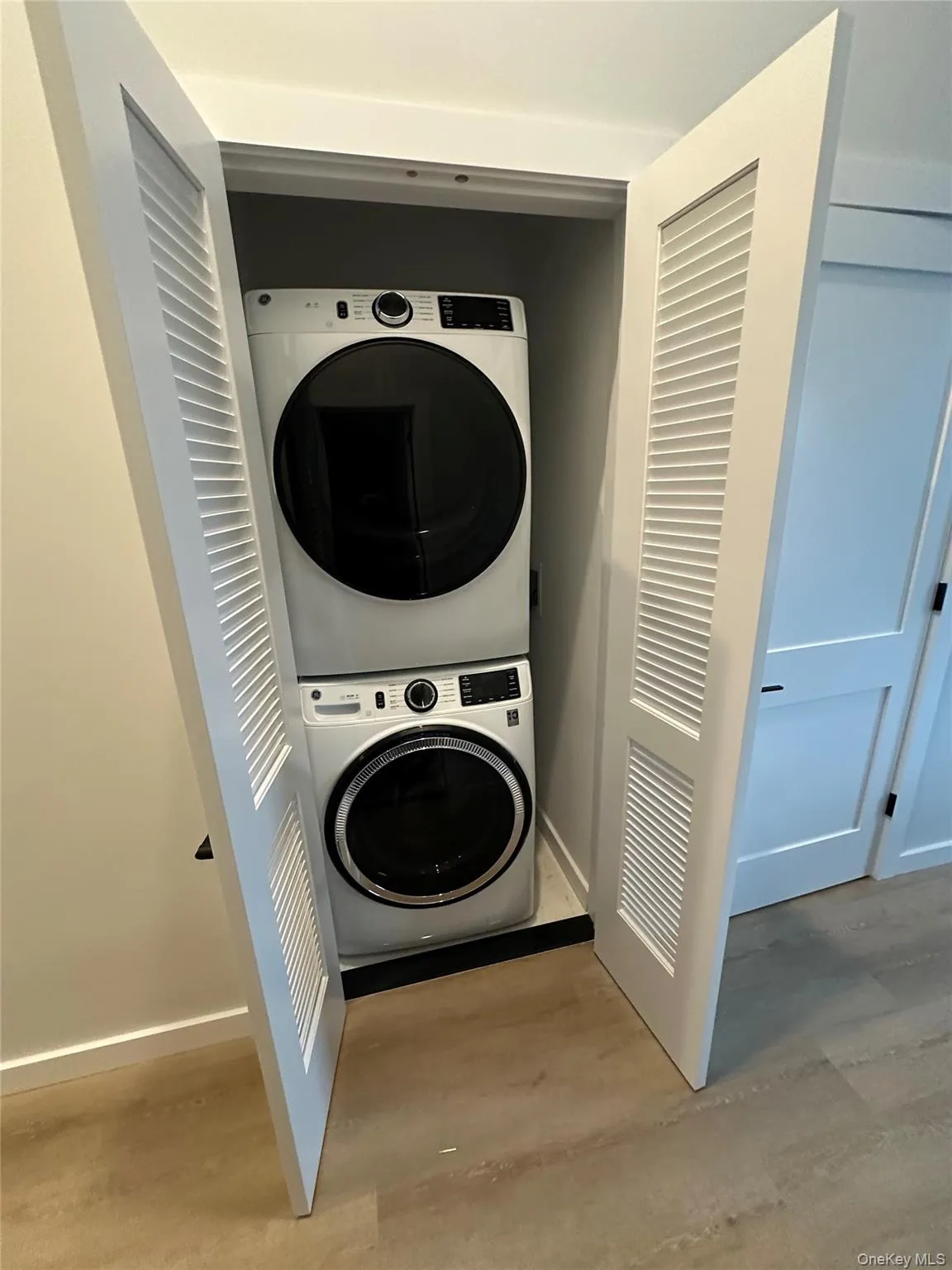 Laundry area with stacked washer / drying machine Laundry area with stacked washer / drying machine