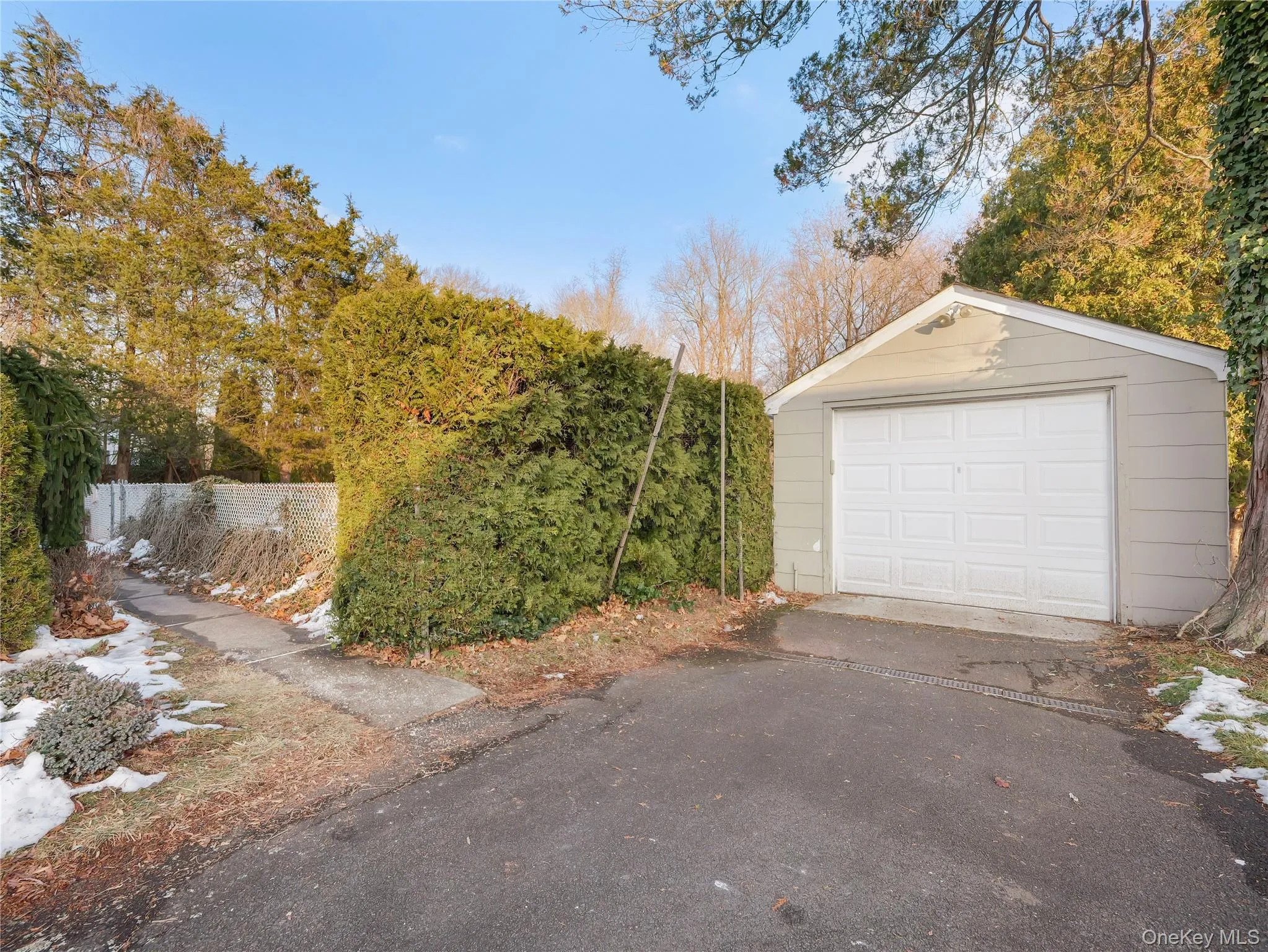 Detached garage featuring asphalt driveway Detached garage featuring asphalt driveway
