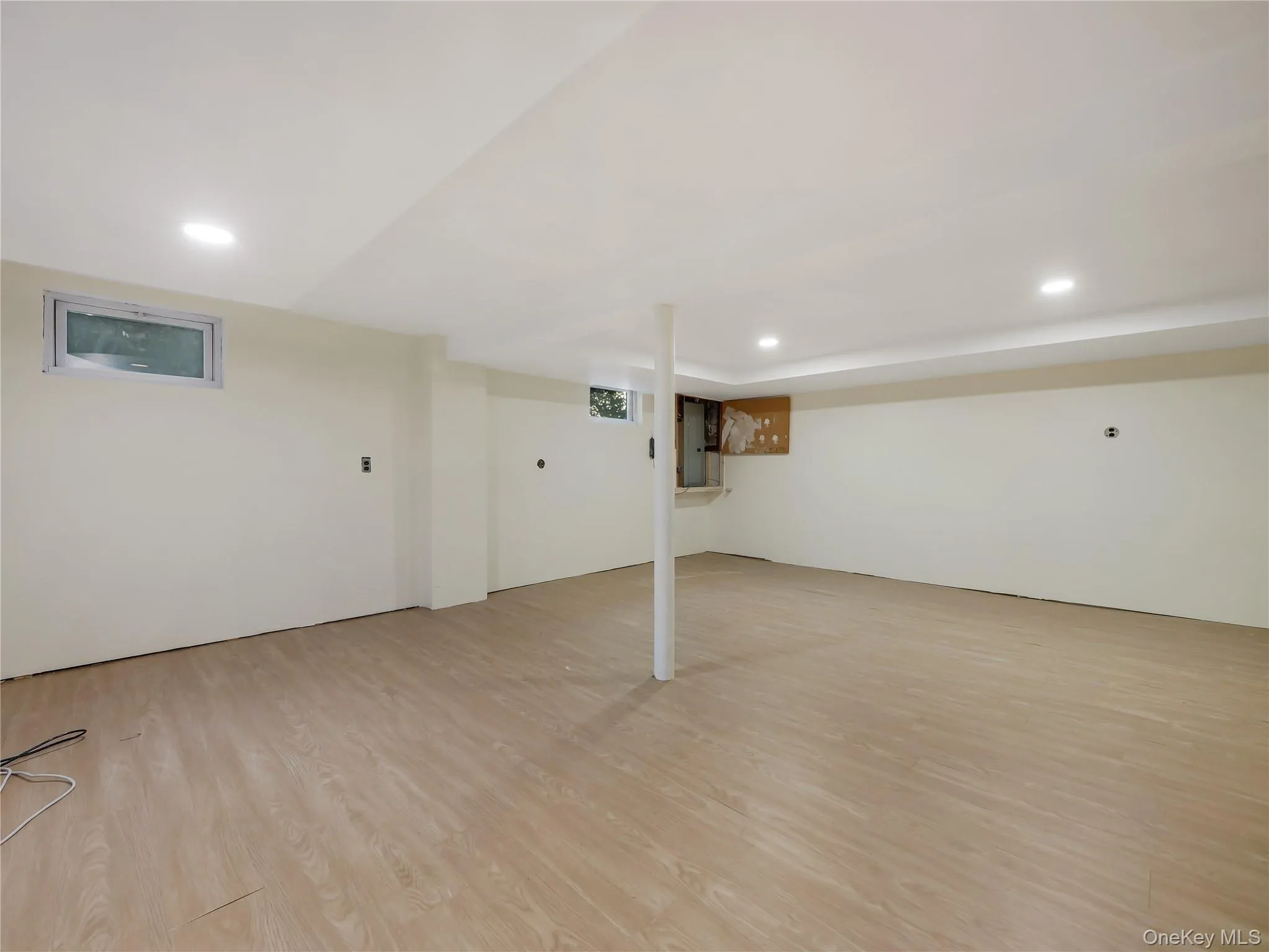Finished basement featuring recessed lighting and light wood-type flooring Finished basement featuring recessed lighting and light wood-type flooring