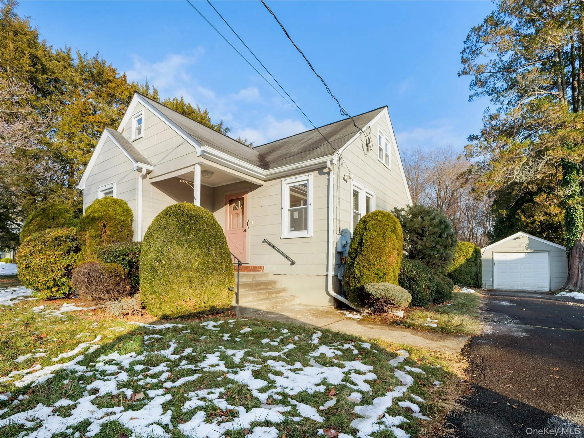 View of side of property featuring an outbuilding, a garage, and asphalt driveway View of side of property featuring an outbuilding, a garage, and asphalt driveway