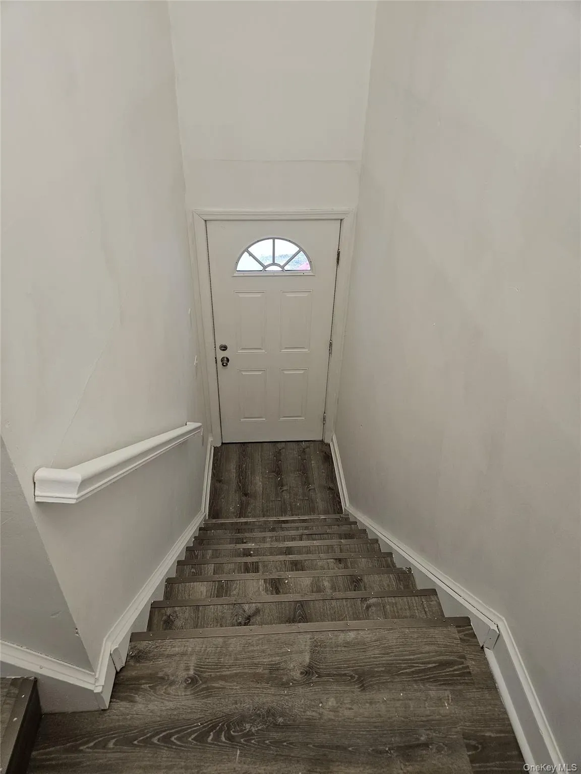 Stairs with wood finished floors and baseboards Stairs with wood finished floors and baseboards