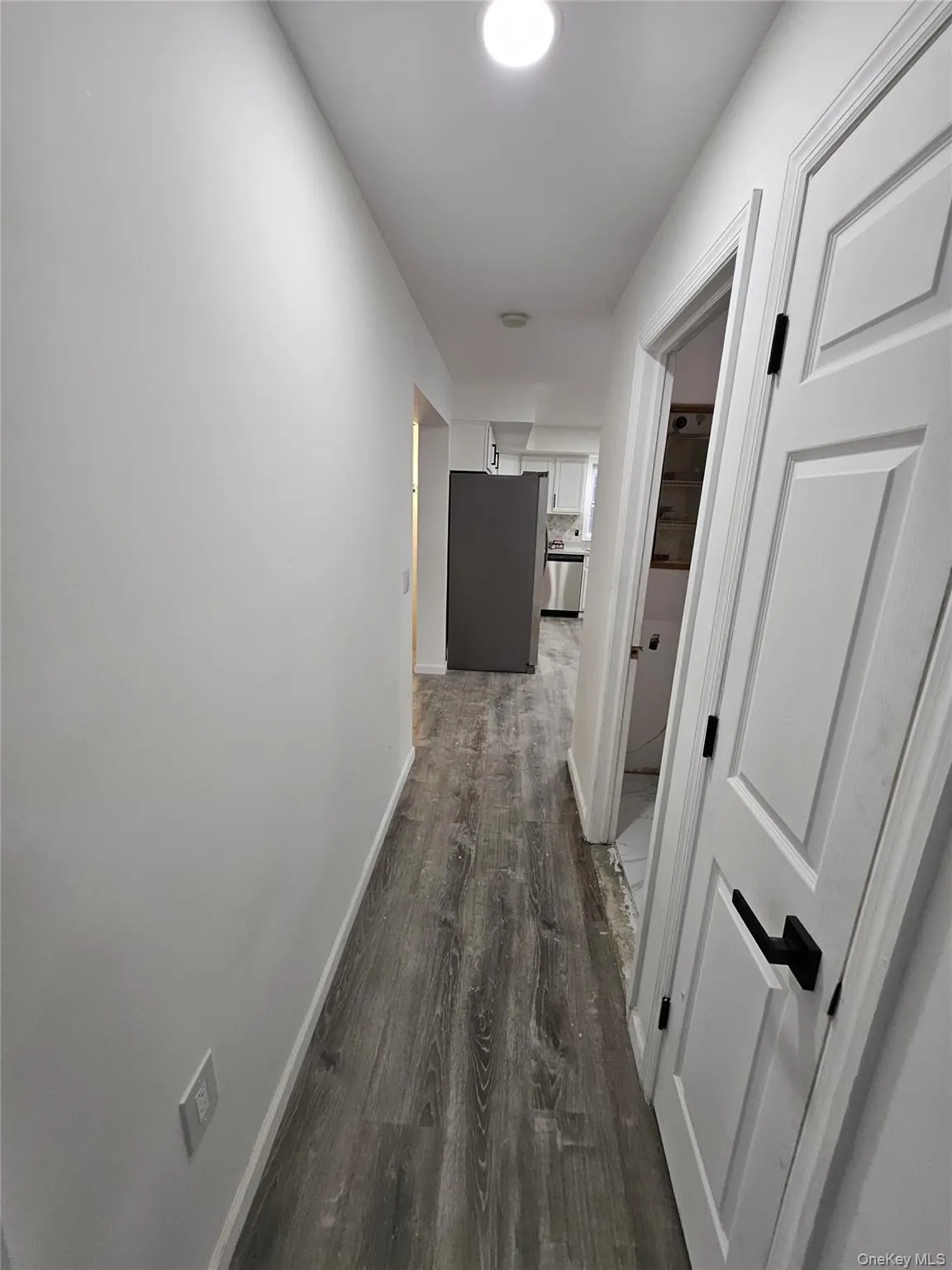 Corridor with dark wood finished floors and baseboards Corridor with dark wood finished floors and baseboards