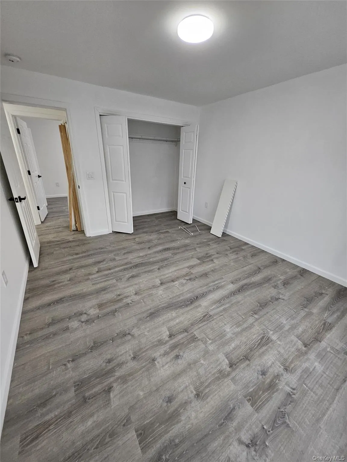 Unfurnished bedroom featuring a closet and light wood-type flooring Unfurnished bedroom featuring a closet and light wood-type flooring
