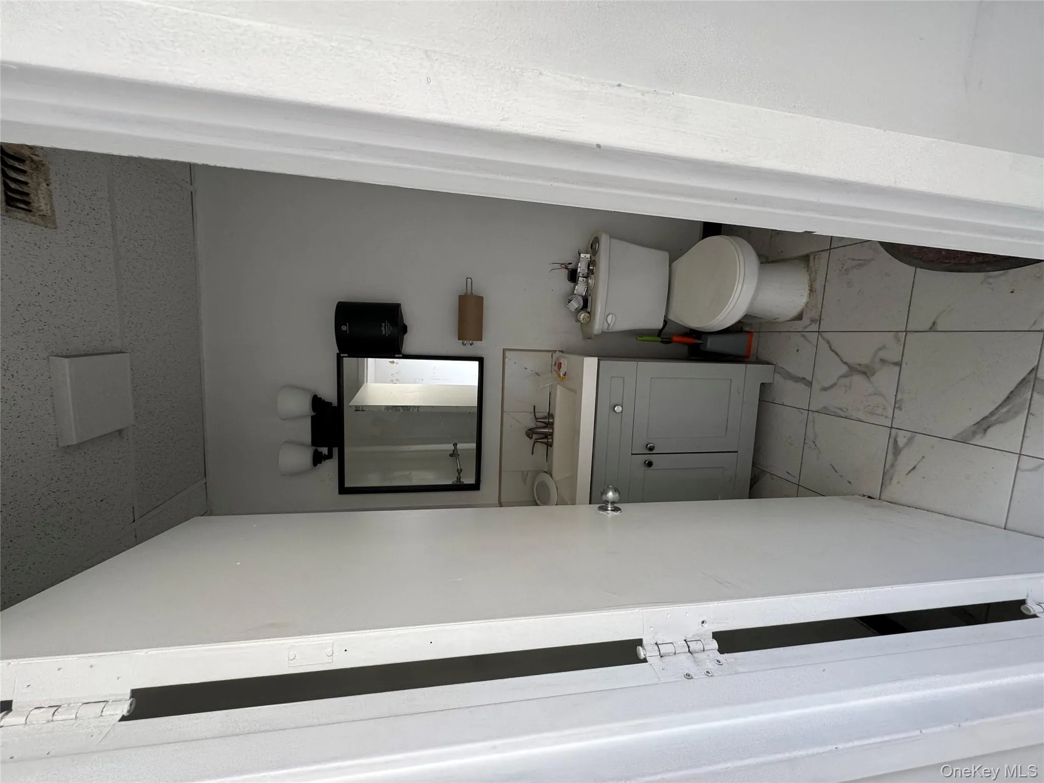 Bathroom featuring vanity and light marble finish flooring Bathroom featuring vanity and light marble finish flooring