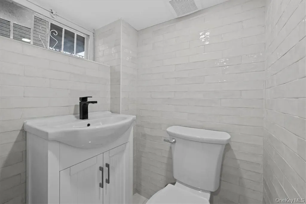 Bathroom with vanity and tile walls Bathroom with vanity and tile walls