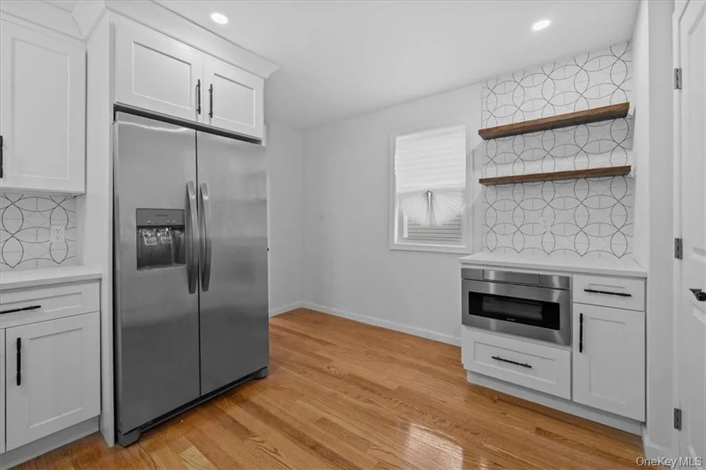 Kitchen featuring backsplash, white cabinetry, and recessed lighting Kitchen featuring backsplash, white cabinetry, and recessed lighting