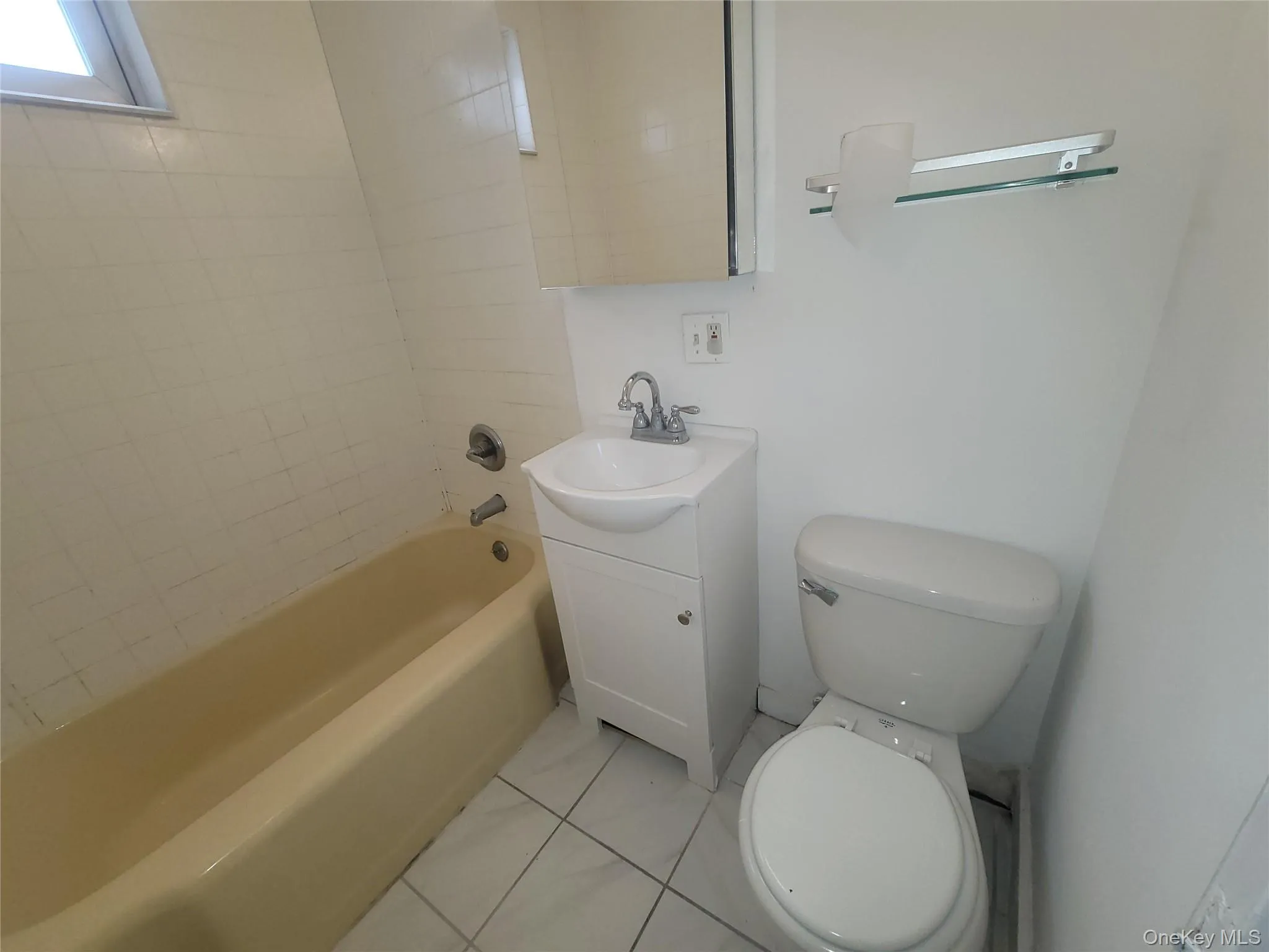 Bathroom with vanity, tub / shower combination, and light tile patterned floors Bathroom with vanity, tub / shower combination, and light tile patterned floors